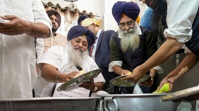 Shiromani Akali Dal leader Sukhbir Singh Badal serves his Tankhah (religious punishment) at the Golden Temple on Wednesday (PTI) Shiromani Akali Dal leader Sukhbir Singh Badal serves his Tankhah (religious punishment) at the Golden Temple on Wednesday (PTI)
