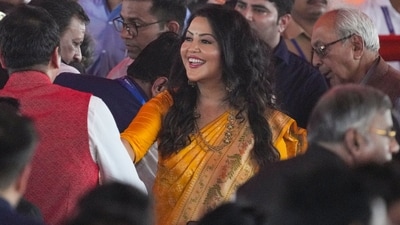 BJP leader Devendra Fadnavis' wife Amruta Fadnavis during her husband's swearing-in ceremony as Maharashtra Chief Minister, in Mumbai, (PTI) BJP leader Devendra Fadnavis' wife Amruta Fadnavis during her husband's swearing-in ceremony as Maharashtra Chief Minister, in Mumbai, (PTI)