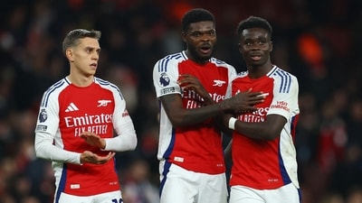 Arsenal's Leandro Trossard, Thomas Partey and Bukayo Saka celebrate after the match (Action Images via Reuters)