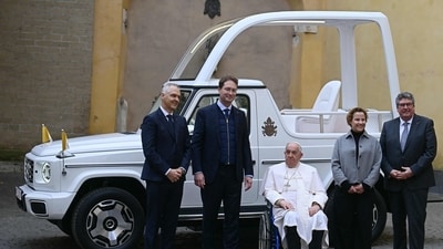 Pope Francis (C) poses with Mercedes CEO Ola Kallenius (2ndR) and Mercedes managers as he's presented a new fully electric popemobile, at the Vatican. (AFP) Pope Francis (C) poses with Mercedes CEO Ola Kallenius (2ndR) and Mercedes managers as he's presented a new fully electric popemobile, at the Vatican. (AFP)