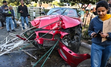 A BMW Z4 convertible was dragged on for nearly 100 metres from the point of collision near Delhi Gate. (HT Photo)