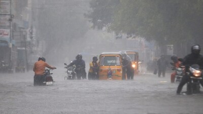 Commuters wade through a waterlogged road following heavy rainfall triggered by Cyclone Fengal, in Chennai on Saturday. Commuters wade through a waterlogged road following heavy rainfall triggered by Cyclone Fengal, in Chennai on Saturday.