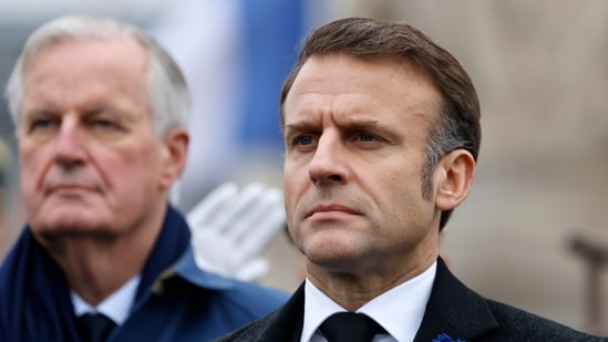 French President Emmanuel Macron, right, and Prime Minister Michel Barnier stand at attention during commemorations marking the 106th anniversary of the November 11, 1918, Armistice, ending World War I, at the Arc de Triomphe in Paris, Monday, Nov. 11, 2024. (AP)