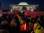 Police officers guard the National Assembly as protesters against South Korean President Yoon Suk Yeol gather outside to chant slogans in Seoul, South Korea on Friday. (AP) Police officers guard the National Assembly as protesters against South Korean President Yoon Suk Yeol gather outside to chant slogans in Seoul, South Korea on Friday. (AP)