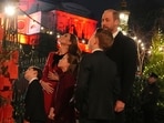 Britain's Prince William, right, Kate, Princess of Wales, Prince George, Princess Charlotte, center, and Prince Louis, left, look at messages on the Kindness Tree at the "Together At Christmas" carol service at Westminster Abbey in London, Britain, Friday, Dec. 6, 2024. (Jordan Pettitt/Pool photo via AP)