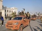 Syrian anti government fighters celebrate as they pour into the captured central-west city of Hama on December 6, 2024.