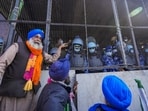 Farmers stand next to the barricades at Shambhu border after commencing their foot march to Delhi.