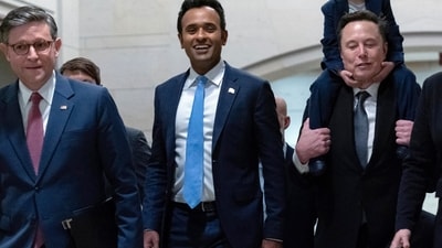 Speaker of the House Mike Johnson walks with Vivek Ramaswamy and Elon Musk, who is carrying his son X Æ A-Xii, as they walk to a meeting to discuss President-elect Donald Trump's planned Department of Government Efficiency, on Capitol Hill in Washington, (AP)