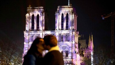 A couple kiss in front of Notre-Dame de Paris cathedral, on the eve of its official reopening after more than five years of reconstruction work following the April 2019 fire, in Paris on December 6, 2024. Notre Dame Cathedral is set to re-open in early December 2024, with a weekend of ceremonies on December 7 and 8, 2024. (AFP)