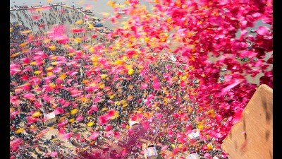 Flower petals being showered from a helicopter on the pilgrims taking the dip at Sangam in Prayagraj (HT FILE) Flower petals being showered from a helicopter on the pilgrims taking the dip at Sangam in Prayagraj (HT FILE)