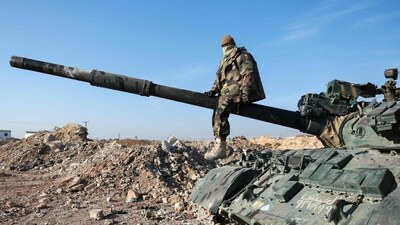 A militant poses for a picture after anti-government fighters seized Syrian army military equipment and vehicles that were abandoned on the highway to Damascus, as they reach the town of Suran north of Syria's Hama city on December 3, 2024. (AFP) A militant poses for a picture after anti-government fighters seized Syrian army military equipment and vehicles that were abandoned on the highway to Damascus, as they reach the town of Suran north of Syria's Hama city on December 3, 2024. (AFP)