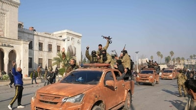 Syrian anti government fighters celebrate as they pour into the captured central-west city of Hama on December 6, 2024. (AFP) Syrian anti government fighters celebrate as they pour into the captured central-west city of Hama on December 6, 2024. (AFP)