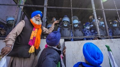 Farmers stand next to the barricades at Shambhu border after commencing their foot march to Delhi. (PTI) Farmers stand next to the barricades at Shambhu border after commencing their foot march to Delhi. (PTI)