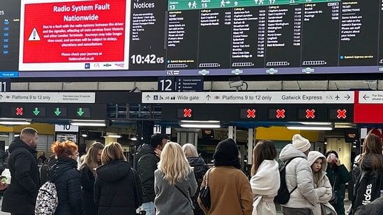 Travellers look at the information board at Victoria Station in London, Friday, Dec. 6, 2024 as rail travellers across Britain are facing disruption after a fault in a radio system used by drivers and signalers nationwide prompted cancellations across the network. (AP Photo)