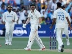 Australia's Travis Head, centre, reacts after he is bowled out by India's Mohammed Siraj. 