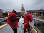 Cyclists wearing raincoats stop their ride during a gust of wind on Millennium Bridge after Storm Darragh hit the country, in London, Britain, December 7, 2024. REUTERS/Isabel Infantes