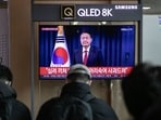 A television screen shows a live footage of South Korean President Yoon Suk Yeol delivering a speech, at Seoul Station in Seoul, South Korea