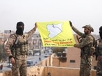 Members of the Kurdish-led Syrian Democratic Forces (SDF) a flag in Deir al-Zor, after U.S.-backed alliance led by Syrian Kurdish fighters captured Deir el-Zor, the government's main foothold in the vast desert, according to Syrian sources, in Syria December 7, 2024.