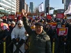 Shin Jae-hyung (C), a 66-year-old protester who participated in South Korea's pro-democracy mass protests in the 1970s and the 80s, takes part in a protest calling for the ouster of South Korea President Yoon Suk Yeol.