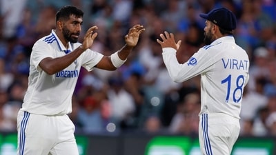 India's Jasprit Bumrah, left, celebrates with teammate Virat Kohli after the dismissal of Australia's Usman Khawaja during the day one of the second cricket test match between Australia and India at the Adelaide Oval. (AP) India's Jasprit Bumrah, left, celebrates with teammate Virat Kohli after the dismissal of Australia's Usman Khawaja during the day one of the second cricket test match between Australia and India at the Adelaide Oval. (AP)