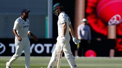 Australia's Mitchell Marsh, right, walks off the field. (AP)