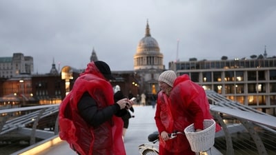Cyclists wearing raincoats stop their ride during a gust of wind on Millennium Bridge after Storm Darragh hit the country, in London, Britain, December 7, 2024. REUTERS/Isabel Infantes (REUTERS)