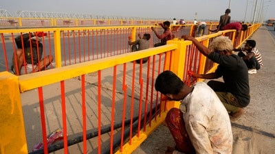 Workers paint the railings of a bridge over the Ganges river.&nbsp; ((AP Photo/Rajesh Kumar Singh))