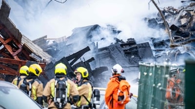 Firemen stand next to a partially collapsed residential building following a fire and an explosion in The Hague on December 7. (AFP) Firemen stand next to a partially collapsed residential building following a fire and an explosion in The Hague on December 7. (AFP)