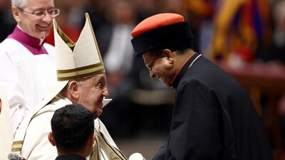 Pope Francis speaks with new Cardinal George Jacob Koovakad during a consistory ceremony to elevate Roman Catholic prelates to the rank of cardinal, in Saint Peter's Basilica at the Vatican. (REUTERS)