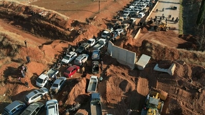 The photo shows people crossing an anti-government checkpoint as return to the town of Saraqib in the eastern part of the Idlib province in northwestern Syria. This marks the fifth day since the takeover. Russian and Iranian backed militias have also entered Syria to fight the rebels. (AFP)