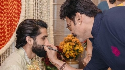 Venkatesh Daggubati puts kala tika on Naga Chaitanya's cheek.