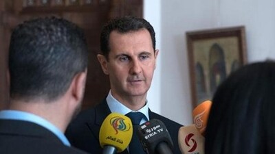 A handout picture released by the official Syrian Arab News Agency (SANA) on March 4, 2018, shows Syrian President Bashar al-Assad (C) talking to reporters in Damascus (AFP) A handout picture released by the official Syrian Arab News Agency (SANA) on March 4, 2018, shows Syrian President Bashar al-Assad (C) talking to reporters in Damascus (AFP)