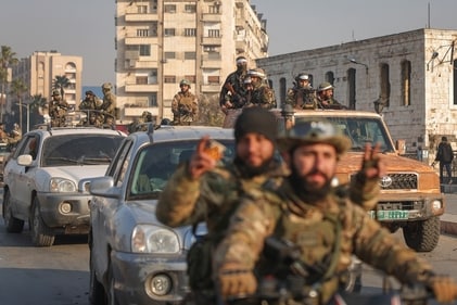 Syrian opposition fighters ride along the streets in the aftermath of the opposition's takeover of Hama, Syria. (AP)