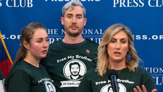 Meagan Malone speaks about their brother Austin Tice, a journalist who was kidnapped in Syria, as Jacob Tice, center, and his wife Cassie Fastabend listen, Friday, Dec. 6, 2024, as the family continues to push for his release during a news conference at the National Press Club in Washington. (AP Photo/Jacquelyn Martin) (AP)