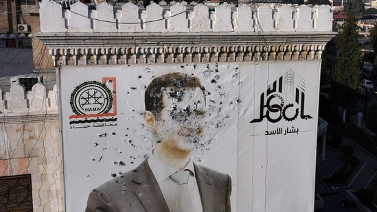 This aerial picture shows a bullet-riddled portrait of Syrian President Bashar al-Assad adorning Hama's municipality building after it was defaced following the capture of the city by anti government fighters on December 6. (AFP)