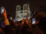 Spectators take snapshots outside France's iconic Notre Dame Cathedral Saturday, December 7, 2024 in Paris during its formal reopening for the first time since a devastating fire nearly destroyed the 861-year-old landmark in 2019. Spectators take snapshots outside France's iconic Notre Dame Cathedral Saturday, December 7, 2024 in Paris during its formal reopening for the first time since a devastating fire nearly destroyed the 861-year-old landmark in 2019.