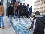 People kick a poster depicting Syrian President Bashar al Assad after Syria's army command notified officers on Sunday that President Bashar al-Assad's 24-year authoritarian rule has ended