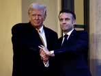 French President Emmanuel Macron shakes hands with U.S. President-elect Donald Trump as he arrives for a meeting at the Elysee Palace in Paris as part of ceremonies to mark the reopening of the Notre-Dame de Paris Cathedral.