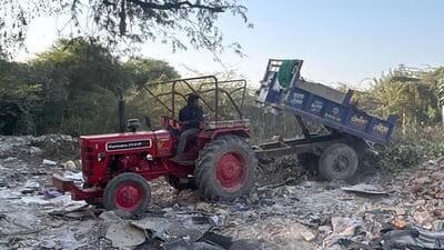 A private tractor dumps the garbage illegally on a vacant land on Wazirabad Road near Sector 52A in Gurugram on December 7. (Parveen Kumar/HT Photo)