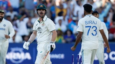 Australia's Travis Head, centre, reacts after he is bowled out by India's Mohammed Siraj. (AP12_07_2024_000129B) (AP) Australia's Travis Head, centre, reacts after he is bowled out by India's Mohammed Siraj. (AP12_07_2024_000129B) (AP)