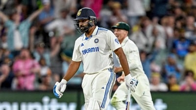 India's captain Rohit Sharma walks back to the pavilion after he is bowled out by his Australian counterpart Pat Cummins. (Photo by Michael ERREY / AFP) (AFP) India's captain Rohit Sharma walks back to the pavilion after he is bowled out by his Australian counterpart Pat Cummins. (Photo by Michael ERREY / AFP) (AFP)