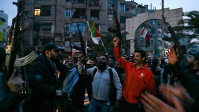 Local residents cheer as the gather on a street in the Damascus suburb of Jaramana on December 8, 2024. Syrian rebels said on December 8 that President Bashar al-Assad had fled the country, calling on citizens abroad to return to a ‘free Syria’. (AFP) Local residents cheer as the gather on a street in the Damascus suburb of Jaramana on December 8, 2024. Syrian rebels said on December 8 that President Bashar al-Assad had fled the country, calling on citizens abroad to return to a ‘free Syria’. (AFP)