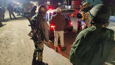 Security personnel check vehicles in a sensitive area of Manipur on December 7 (PTI Photo) Security personnel check vehicles in a sensitive area of Manipur on December 7 (PTI Photo)