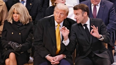 French President Emmanuel Macron (R) gestures as he talks with US President-elect Donald Trump (C) inside Notre-Dame Cathedral. (AFP) French President Emmanuel Macron (R) gestures as he talks with US President-elect Donald Trump (C) inside Notre-Dame Cathedral. (AFP)