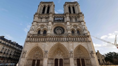 People walk in front of the Notre-Dame de Paris cathedral, ahead of its official reopening ceremony. (AFP) People walk in front of the Notre-Dame de Paris cathedral, ahead of its official reopening ceremony. (AFP)