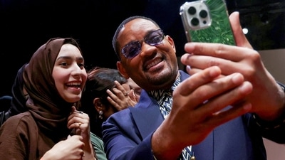 Will Smith poses for a photos with fans as he arrives to attend the of the opening ceremony. (AFP) Will Smith poses for a photos with fans as he arrives to attend the of the opening ceremony. (AFP)