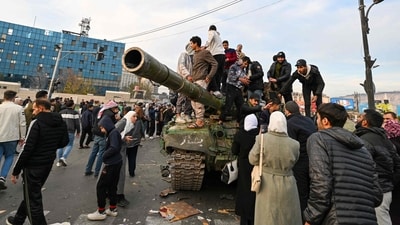 People stand atop a tank celebrating at Umayyad Square in Damascus. (AFP) People stand atop a tank celebrating at Umayyad Square in Damascus. (AFP)