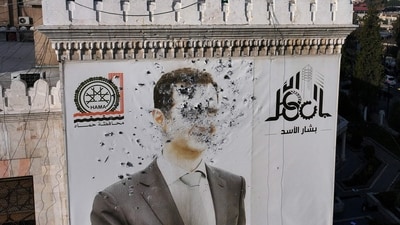A bullet-riddled portrait of Syrian President Bashar al-Assad adorning Hama's municipality building after it was defaced following the capture of the city by rebels. (AFP) A bullet-riddled portrait of Syrian President Bashar al-Assad adorning Hama's municipality building after it was defaced following the capture of the city by rebels. (AFP)