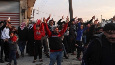 Residents cheer Syrian anti-government fighters as they enter the west-central city of Hama. (AFP) Residents cheer Syrian anti-government fighters as they enter the west-central city of Hama. (AFP)