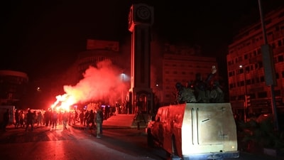 Syrians celebrate in the main square of Homs early on December 8, 2024, after rebel forces entered Syria's third city overnight. (AFP) Syrians celebrate in the main square of Homs early on December 8, 2024, after rebel forces entered Syria's third city overnight. (AFP)